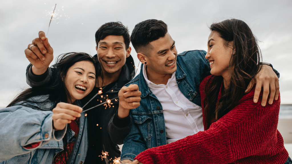 Friends celebrating with sparklers outdoors.