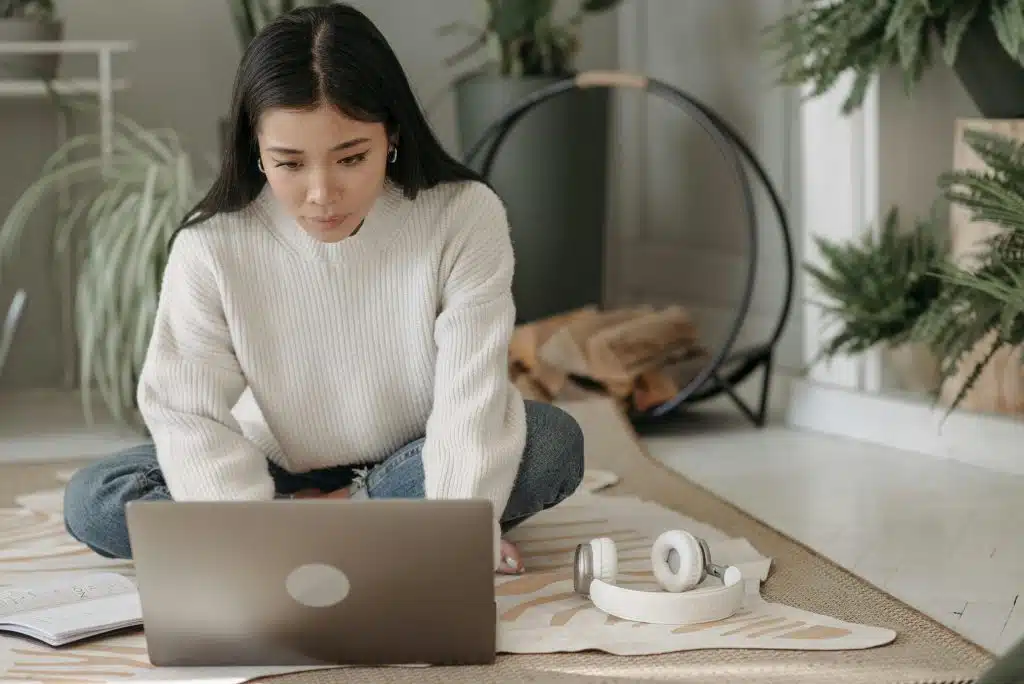 Person working on laptop at home.