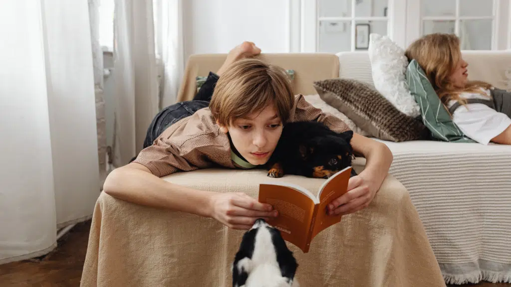 Young person lying on bed coping with a difficult parental relationship