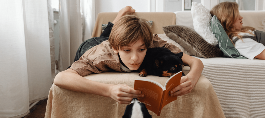 Young person lying on bed coping with a difficult parental relationship