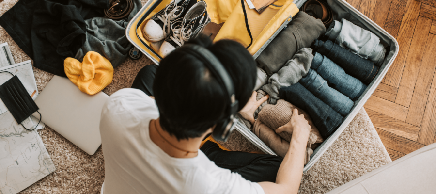 Young man packs his case as he's navigating life in two homes